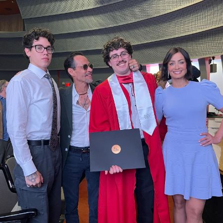 Cristian Marcus Muniz with his family took a picture of his graduation.